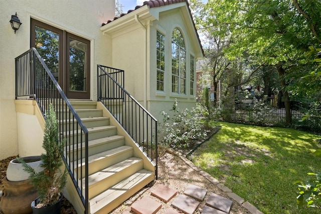 entrance to property featuring a lawn