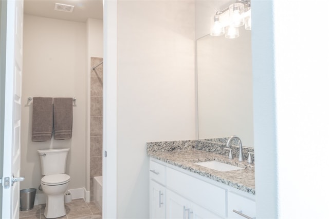 bathroom featuring tile patterned floors, vanity, and toilet