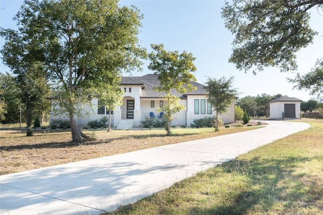 view of front of property with a front yard and a storage unit