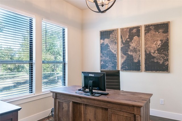 office space featuring dark wood-type flooring and an inviting chandelier