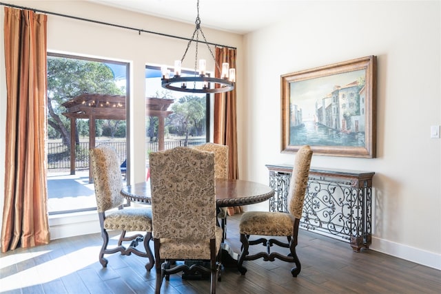 dining area with an inviting chandelier and dark hardwood / wood-style flooring