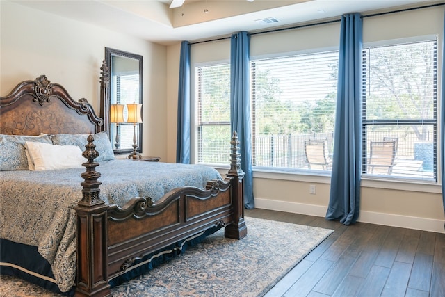 bedroom with dark hardwood / wood-style flooring and ceiling fan