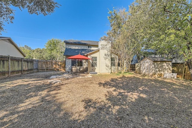 4910 Pelham Dr, Austin, TX 78727 - rear view of house with a fenced backyard, a storage shed, a patio area, and a chimney
