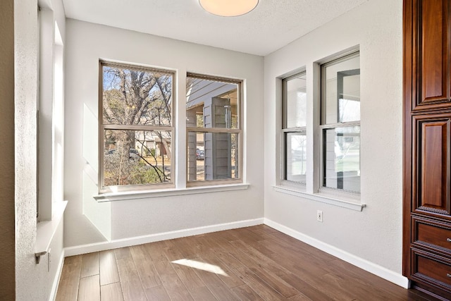 4910 Pelham Dr, Austin, TX 78727 - spare room featuring dark wood-style flooring and baseboards