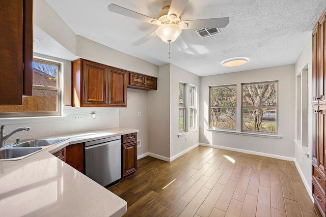 4910 Pelham Dr, Austin, TX 78727 - kitchen featuring dishwasher, light countertops, healthy amount of natural light, and tasteful backsplash