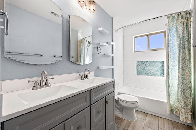4910 Pelham Dr, Austin, TX 78727 - bathroom with shower / tub combo, double vanity, and wood finished floors