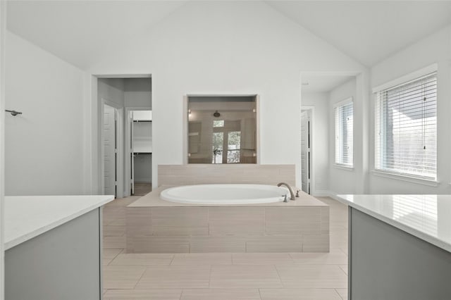 bathroom with vanity, vaulted ceiling, and shower with separate bathtub