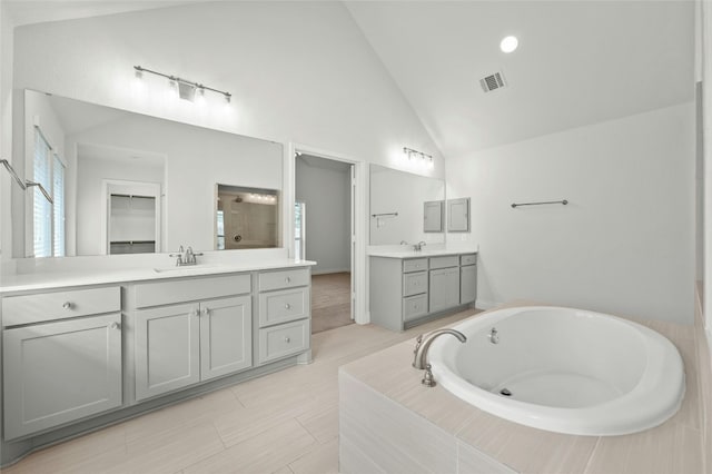 bathroom featuring vanity, tile patterned flooring, separate shower and tub, and high vaulted ceiling