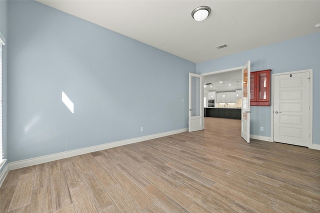 empty room featuring hardwood / wood-style flooring and sink