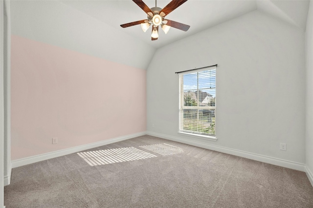 carpeted empty room featuring vaulted ceiling and ceiling fan