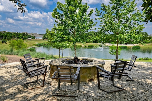 view of patio / terrace with a fire pit and a water view