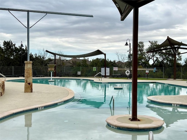 pool featuring a patio area and fence