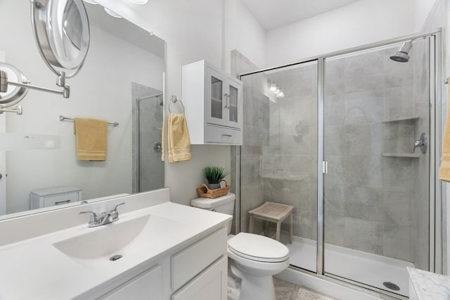 bathroom with vanity, an enclosed shower, and toilet