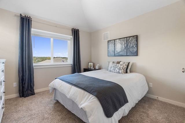 bedroom with vaulted ceiling, carpet floors, visible vents, and baseboards