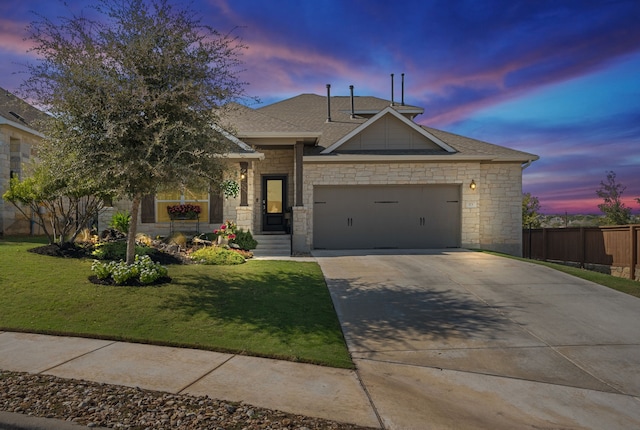 view of front of home with a lawn and a garage