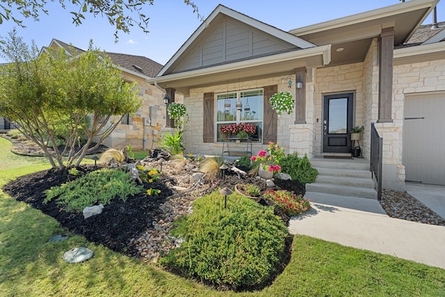 view of front of house with a garage and stone siding