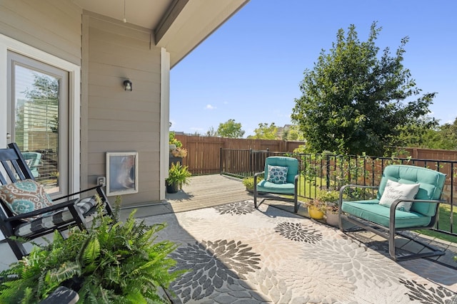 view of patio with fence and a wooden deck