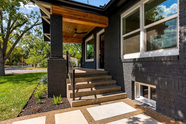 view of exterior entry with a lawn