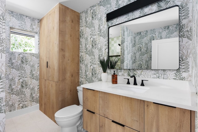 bathroom featuring tile patterned flooring, vanity, and toilet