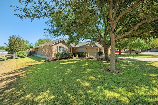 ranch-style house featuring a front lawn and a garage