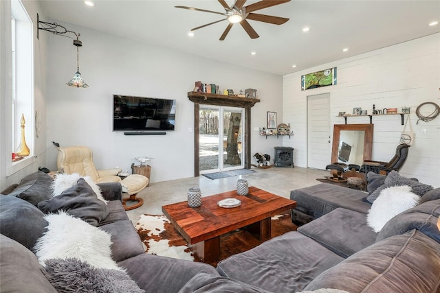 living room with ceiling fan and concrete floors