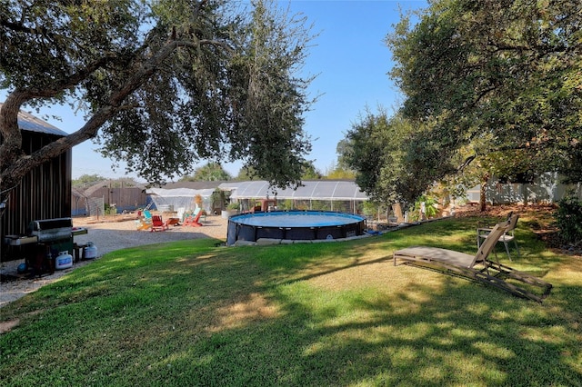 view of yard featuring a fenced in pool