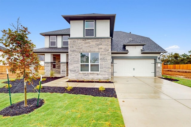 view of front of house with a garage and a front lawn