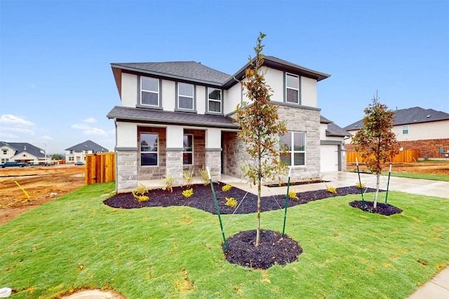 view of front of house with a front yard and a garage