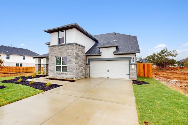 view of front facade featuring a front yard and a garage