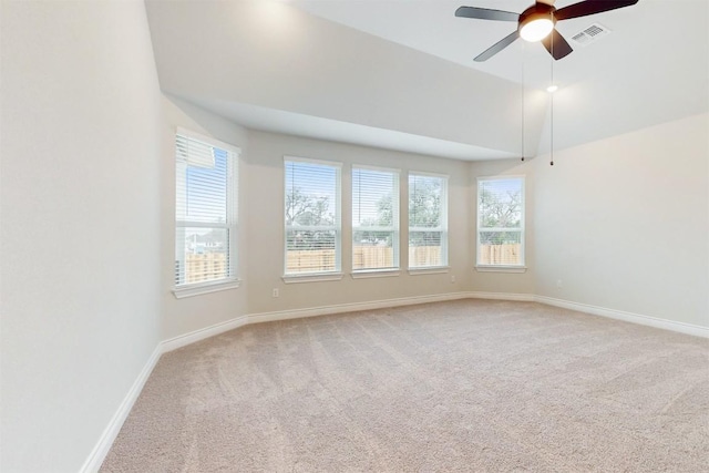 carpeted empty room with plenty of natural light and ceiling fan