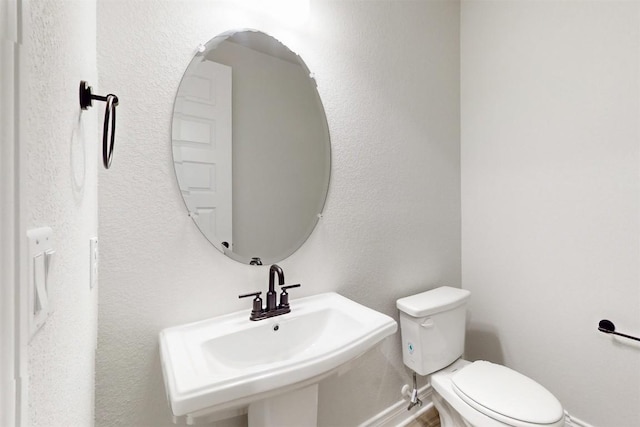 bathroom with toilet and sink