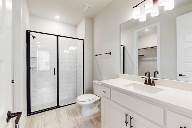 bathroom with vanity, toilet, and walk in shower