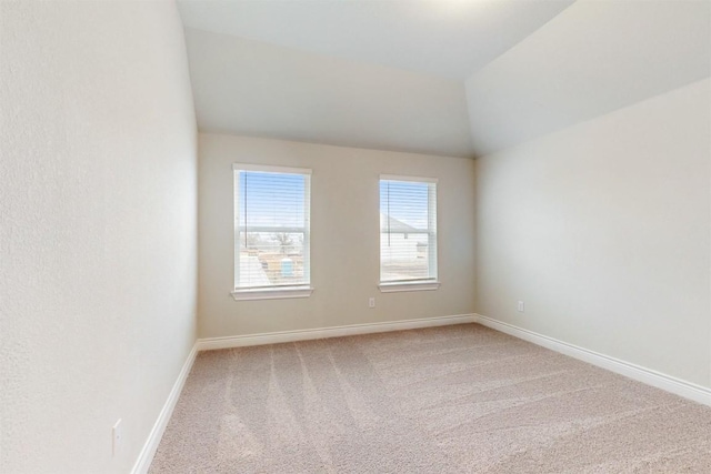 empty room with carpet and lofted ceiling