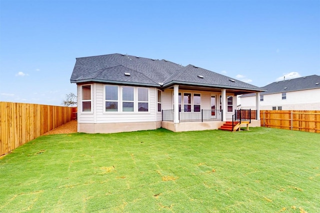 rear view of property with a lawn