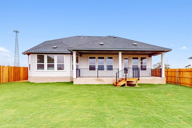 rear view of house with a lawn