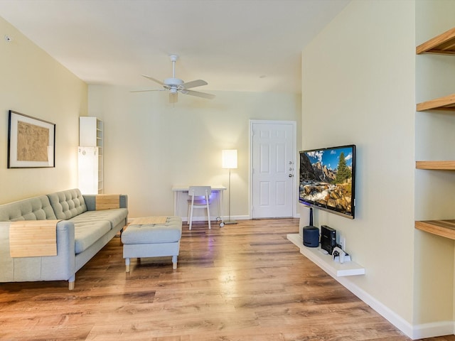 living room featuring ceiling fan and light hardwood / wood-style floors