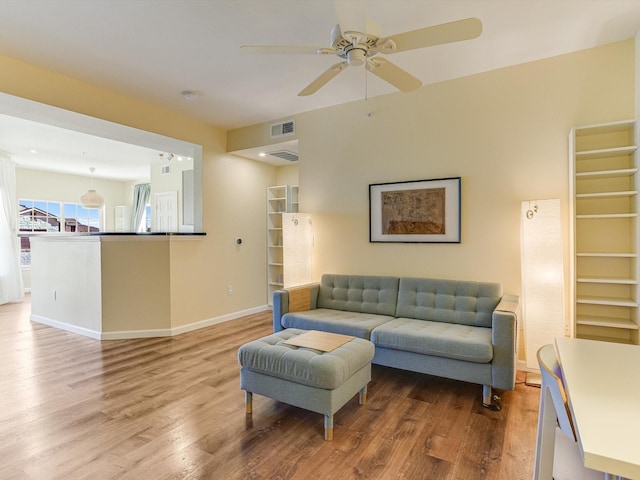 living room with ceiling fan and hardwood / wood-style flooring