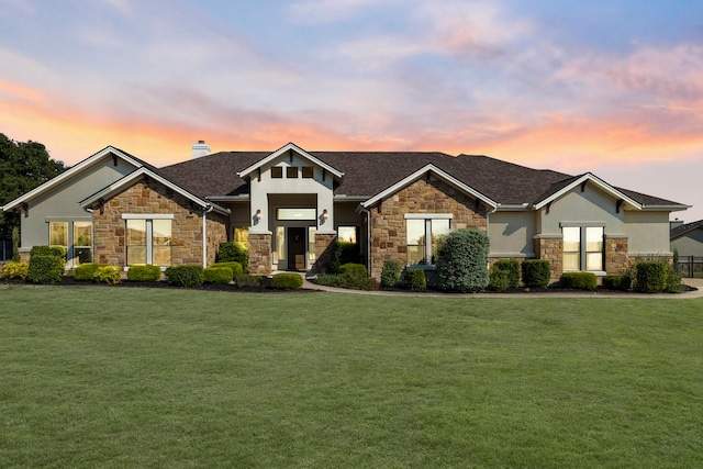 craftsman-style house with a front lawn and stucco siding