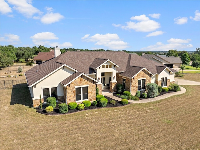 craftsman inspired home featuring fence, a front lawn, and stucco siding