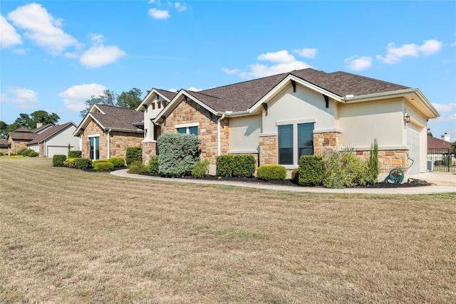 craftsman house with a garage, stone siding, a front yard, and stucco siding