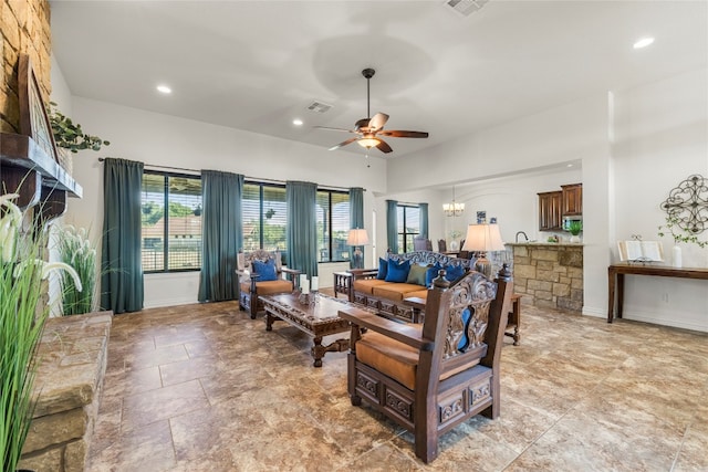 living room with recessed lighting, visible vents, baseboards, and ceiling fan with notable chandelier