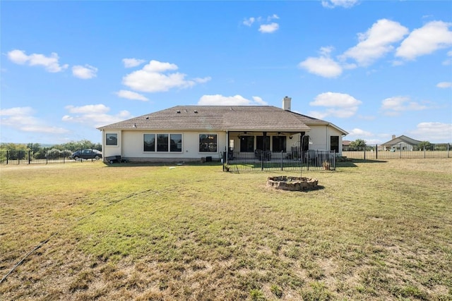 504 Pheasant Mdw, Liberty Hill, TX 78642 - back of property featuring a fire pit, a chimney, and stucco siding