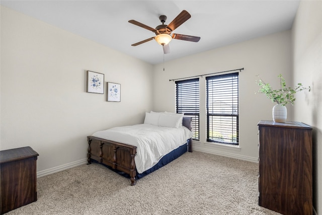 bedroom featuring baseboards, a ceiling fan, and light colored carpet