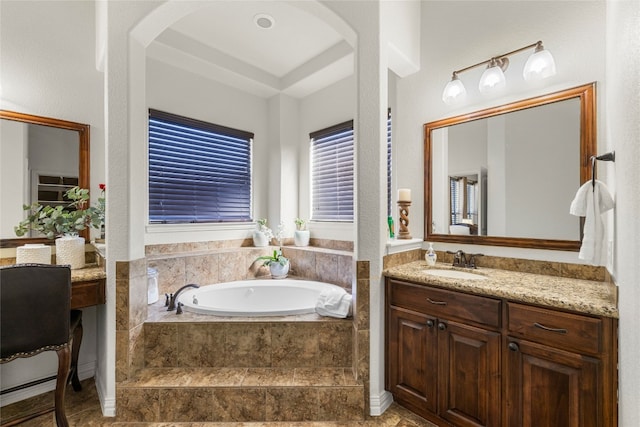 bathroom featuring vanity and tiled bath