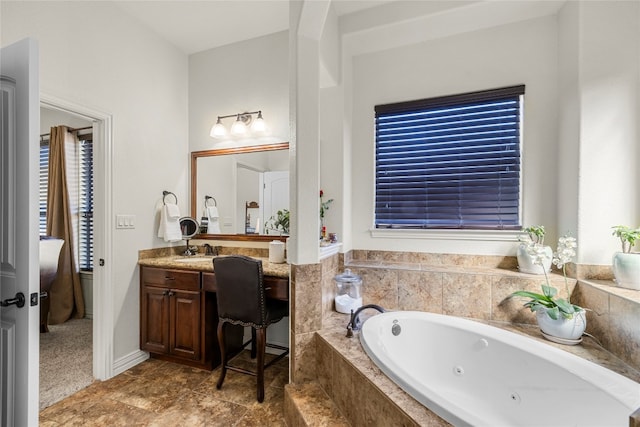 bathroom with vanity and tiled bath