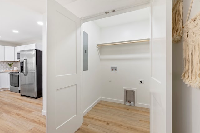 laundry area featuring washer hookup, electric panel, electric dryer hookup, and light wood-type flooring