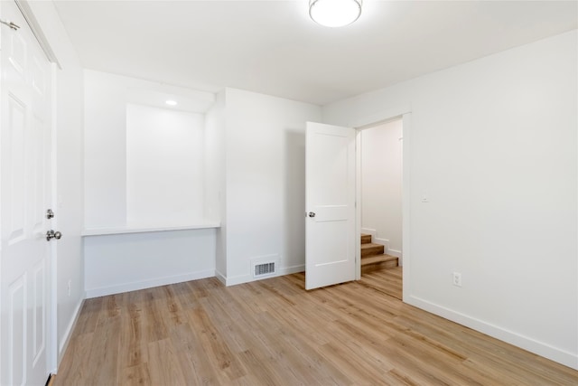 unfurnished bedroom with light wood-style flooring, baseboards, and visible vents