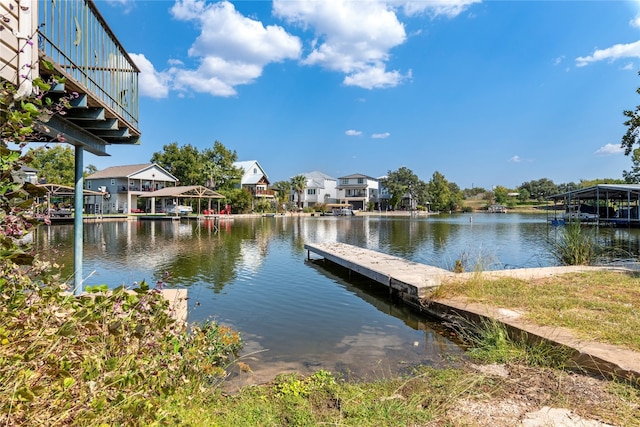 dock area featuring a residential view and a water view