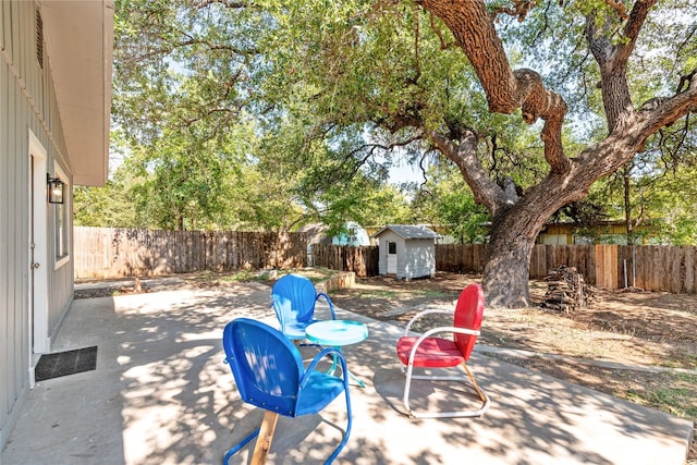 view of patio with a fenced backyard, a shed, and an outdoor structure