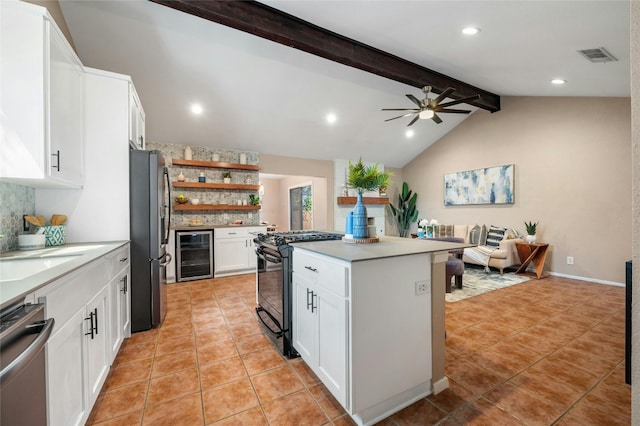 kitchen with a center island, white cabinetry, vaulted ceiling with beams, appliances with stainless steel finishes, and wine cooler